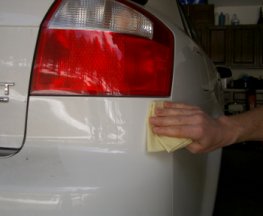 Use rubbing compound to polish the repaired paint scratch.