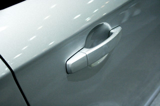 Auto paint chip repair on a car door.